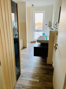 a bathroom with a sink and a mirror at Haus Meerruhe Karlshagen Apartment 7 in Ostseebad Karlshagen