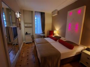 a hotel room with two beds and a television at Avicenna Hotel in Istanbul