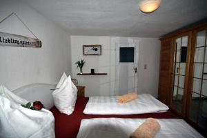 1 dormitorio con 2 camas con sábanas blancas en Ferienwohnung Sonnenaufgang, en Penig