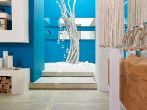 a room with blue walls and a staircase with a fountain at Artemis Seaside Resort in Paliochori