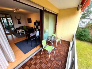 a balcony with a table and chairs on a patio at Apartment am Wendelinus Bad Kissingen in Bad Kissingen +6 photos