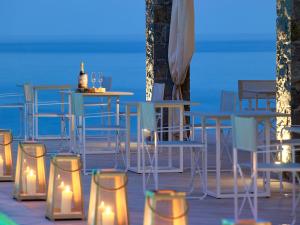 a table and chairs with candles on a patio at Artemis Seaside Resort in Paliochori