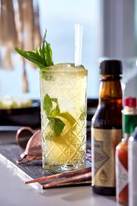 a drink sitting on a table next to a bottle at Artemis Seaside Resort in Paliochori