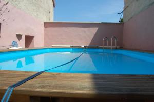 a swimming pool with blue water in a building at Ferme de Chaouen in Fulvy