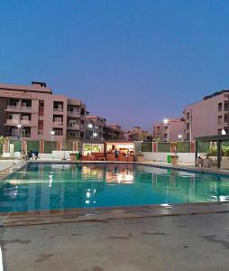 an empty swimming pool in a city with buildings at Zayed dunes in 6th Of October