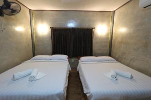 Letto o letti in una camera di Baan Khue Wieng Resort