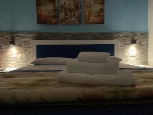 a bedroom with a bed with two pillows on it at Affittacamere Le Ginestre in Colleferro