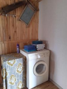 a washer and dryer in a corner of a room at Brīvdienu lauku māja Budnieki in Akmeņdziras