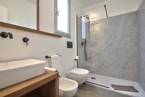 a bathroom with a sink and a toilet and a shower at Home del Corso in Capo dʼOrlando