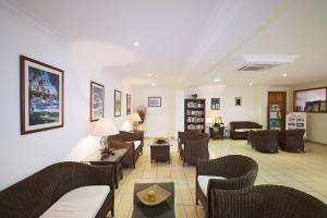 a living room with couches and chairs at Club Aphrodite in Erimi