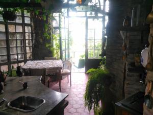 a kitchen with a sink and a table in a room at Barranca del Paraná in Paganini
