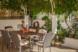 a wooden table and chairs on a patio at Villa Rossa 2 in Tučepi