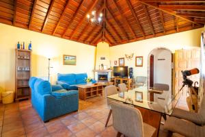 a living room with a blue couch and a table at CASA VAN DE WALLE in Tijarafe