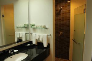 a bathroom with a sink and a mirror at The Bayview Beach Resort in Batu Ferringhi