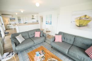 a living room with two couches and a table at SeaWatch-Sea Views in Middleton
