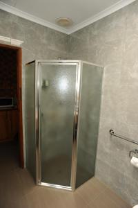 a shower with a glass door in a bathroom at Horsham Mid City Court Motel in Horsham