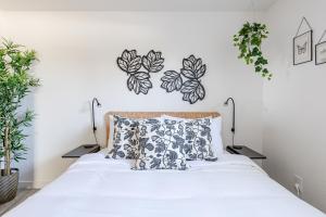 a bedroom with a bed with plants on the wall at Well-Stocked, Family Friendly Home on the Westside STR-1669 in Colorado Springs