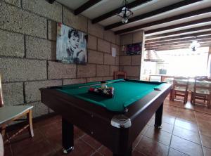 a room with a pool table in a room with a wall at Casa Cielito Lindo in Las Eras