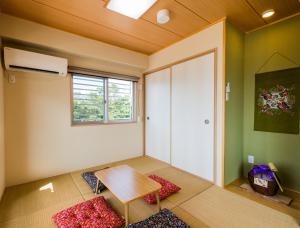 a room with a table and a window and a door at Four Season Resort Kouri Island in Nakijin