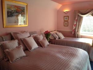 two beds in a room with pink walls at Carmichael in Edinburgh