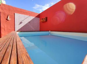 a swimming pool in a building with a red wall at Casa Cielito Lindo in Las Eras