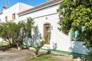 a white house with trees in front of it at El Huerto in Firgas