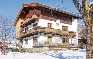 a large wooden house with a balcony in the snow at 3 Bedroom Gorgeous Apartment In Stumm in Stumm