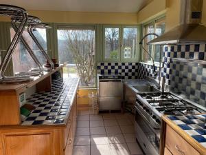 a kitchen with a sink and a stove top oven at Du côté de chez Sam in Andelaroche