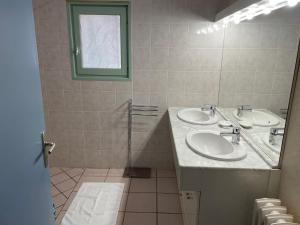 a bathroom with two sinks and a mirror at Du côté de chez Sam in Andelaroche +68 photos