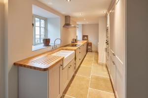 a large kitchen with a sink and a window at Host & Stay - The Cobbles in Osmotherley