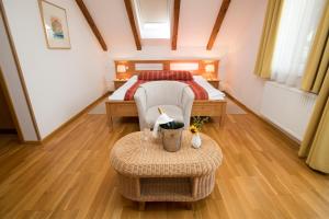 a bedroom with a bed and a table in a room at Art Hotel Kristal in Bohinj