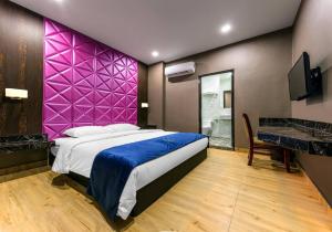 a bedroom with a large bed and a large window at U3 HOTEL in Subang Jaya