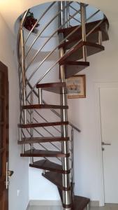 a wooden spiral staircase in a house at Apartments Lumbarda in Lumbarda