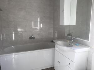 a bathroom with a white tub and a sink at Apartments Lumbarda in Lumbarda