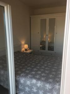 a bedroom with a bed and a lamp on a table at Apartments Lumbarda in Lumbarda