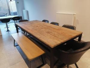 a wooden table and chairs in a room at The Front Door N28 in Ypres