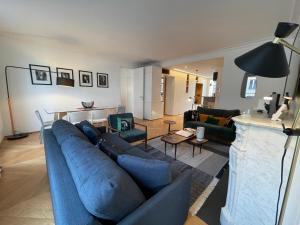 a living room filled with furniture and a tv at RESIDENCES HARCOURT - Ile Saint Louis - PARIS in Paris