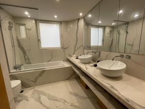 a bathroom with two sinks and a toilet and a mirror at RESIDENCES HARCOURT - Ile Saint Louis - PARIS in Paris