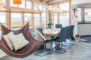 a room with a table and chairs and a hammock at Apart Relax in Längenfeld