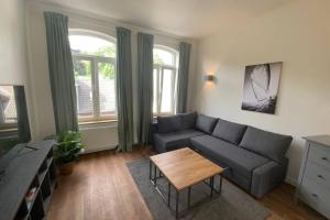 uma sala de estar com um sofá e uma mesa em FeWoEcK Optimist em Eckernförde