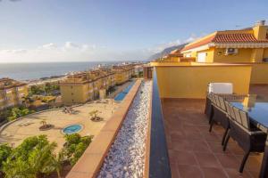 a balcony of a building with a view of the ocean at Casa Tres Vistas Luxury apartment with stunning views to the ocean in Puerto de Santiago