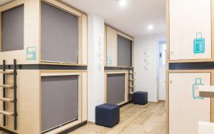 a room with a row of garage doors at TAKE SURF Hostel Conil in Conil de la Frontera +176 photos