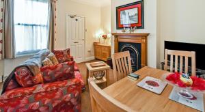 a living room with a couch and a table at York Apartment Conway Cottage in York