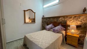 Säng eller sängar i ett rum på Apartamentos Rurales Casa Josefita