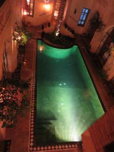 an overhead view of a swimming pool in a building at Dar Tozeur in Tozeur