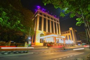 a large building with lights on top of it at night at Quality Inn Sabari in Chennai