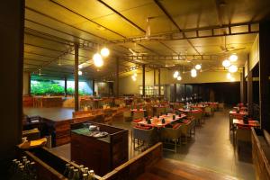 a restaurant with tables and chairs in a room at Wayanad Wild - A CGH Earth Experience in Vythiri