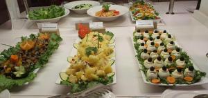 a buffet of different types of food on a table at African Princess Beach Hotel in Serekunda