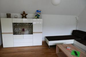 a living room with a couch and a table at Ferienhaus Lütsche in Frankenhain