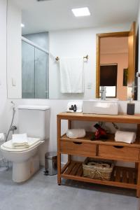 a bathroom with a toilet and a sink and a mirror at Flat Tatuapé Sua Casa Your Home in Sao Paulo